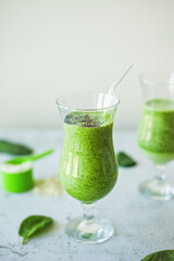 Healthy green protein smoothie, packed with spinach, banana and vanilla protein powder, topped with chia seeds, great for weight loss, detox and a rich source of vitamins, minerals, and antioxidants