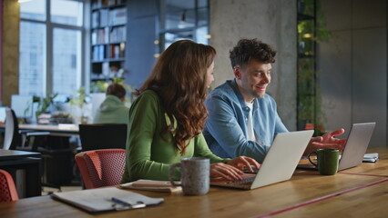 Laughing coworkers discussing business in office closeup. Managers giving five