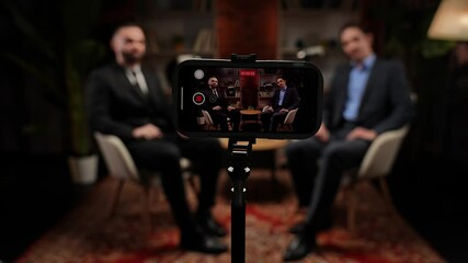 Two experts talking in a cozy, loft-style podcast studio