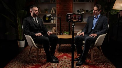 Two experts talking in a cozy, loft-style podcast studio