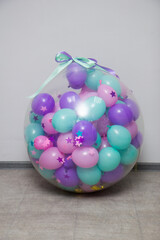 big transparent surprise balloon with small balloons inside