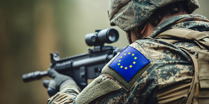 closeup of a determined soldier of the EU aiming with his modern weapon. Camouflage uniform with european union flag patch on his shoulder Europe army concept - Powered by Adobe