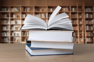 stack of reading books on desk in library