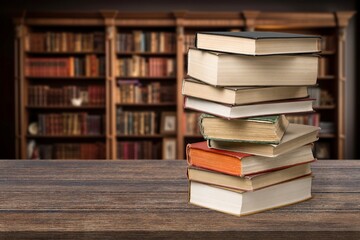 stack of reading books on desk in library