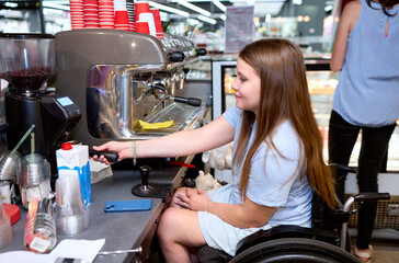 A young woman in a wheelchair confidently prepares coffee in a bustling café. This image captures...