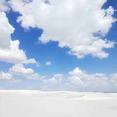 A vast expanse of white sand dunes under a clear blue sky with fluffy white clouds.