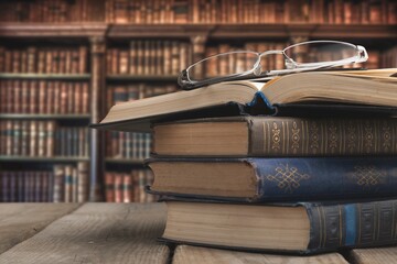 stack of books in library on wooden table