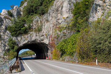 Tunnel through massive mountains on road highway