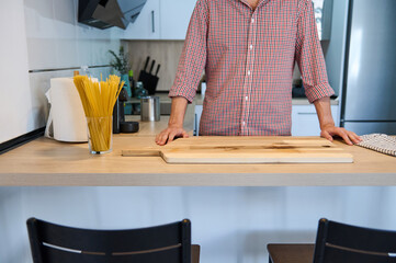 Man Preparing Pasta in Modern Kitchen