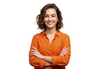 A young woman with short wavy brown hair wearing an orange shirt isolated stands with her arms crossed on transparent background