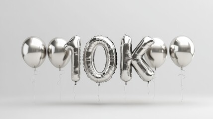 Silver balloons forming 10k celebration against minimalist gray background