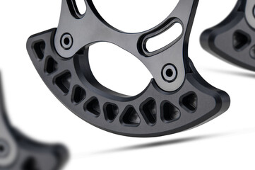 Taco Bashguard bicycle part designed for bicycle  chainrings isolated on white background floating above the ground.