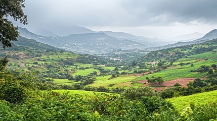 Obraz premium Mountain valley vista, lush green fields, dramatic clouds. Possible use nature background
