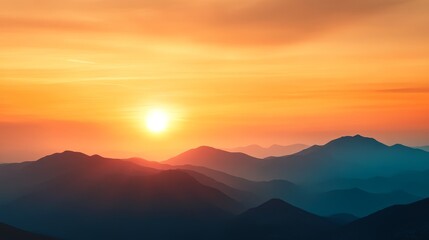 Obraz premium Serene sunset over layered mountains with soft hues reflecting in the sky and horizon