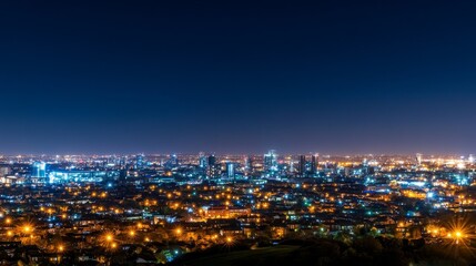 Obraz premium Night cityscape view showcasing illuminated buildings and urban life under a starry sky