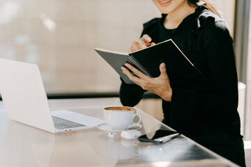 Focused Professional at Work: An Asian woman, deeply engrossed in her work, is depicted at a sleek...