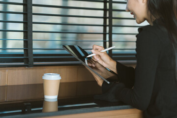 Digital Sketch: An professional is working using digital tablet and a cup of coffee, beside the...