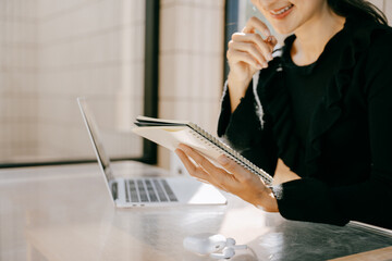 Thoughtful Study with a notebook: A captivating image of a woman engrossed in reading a notebook at...