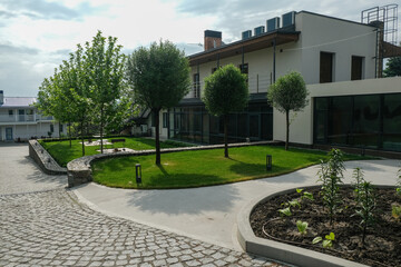 View of a modern country cottage with a green area.
