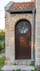 The interesting door with a round window of the old Waldheim Church built by in the Templar style by Germans in Alonei Abba in Israel.

