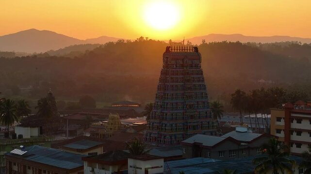 Aerial view of Sringeri Sharada Temple, located in the Chikkamagaluru district of Karnataka, India, alongside the serene Tunga River at sunset.