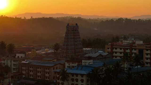 Aerial view of Sringeri Sharada Temple, located in the Chikkamagaluru district of Karnataka, India, alongside the serene Tunga River at sunset.