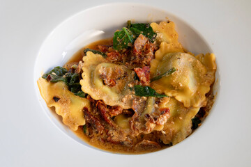 Top view of sun dried tomato ravioli pasta .