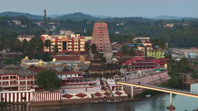 Aerial view of Sringeri Sharada Temple, located in the Chikkamagaluru district of Karnataka, India, alongside the serene Tunga River at sunset.