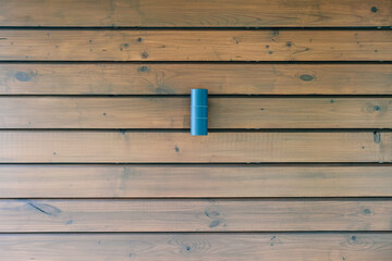 Wooden wall of a building with a street lamp