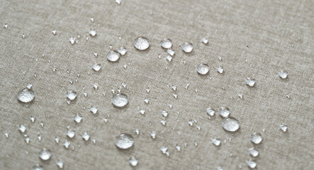 Water drops on a beige water-repellent fabric.