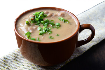 Delicious dish of Brazilian cuisine called Caldo de Feijão. Made with black beans, bacon and sausage. Bean broth. feijoada