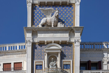 St Mark's Clock tower on Piazza San Marco, Lion of Saint Mark relief on facade, Venice, Italy