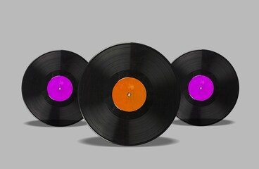 background of old black vinyl records in different colors.