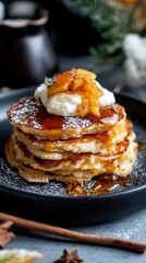 Delicious stack of apple cinnamon pancakes with whipped cream and syrup. National Pancake Week