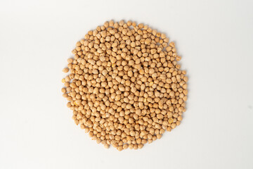 Many chickpeas scattered on a white background, isolated, top view, raw uncooked legumes, healthy organic food, high-protein vegetarian ingredient, nutritious dried peas, agriculture harvest