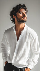 Obraz premium Handsome man in a white shirt looking away in natural light for fashion and lifestyle concepts - vertical format