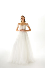 Elegant bride wearing a stunning white wedding dress in a soft-lit studio setting