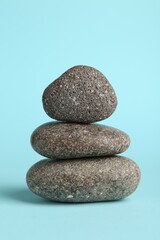 Stack of rocks on light blue background. Harmony and life balance