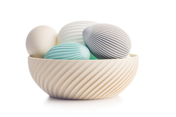 Easter decoration. Colorful eggs in bowl isolated on white background.