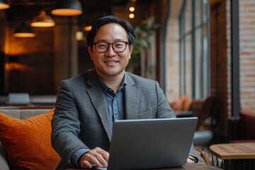 Professional man working on laptop in stylish cafe during daytime