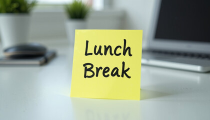 Lunch break note on yellow sticky pad at office workspace