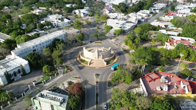 aerial view of monument of la patria on boulevard paseo de montejo in merida yucatan mexico (national heritage monument to the homeland) travel tourism destination with traffic going around a circle
