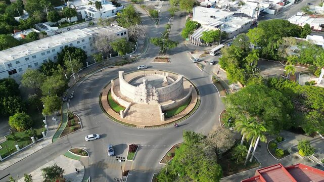 aerial view of monument of la patria on boulevard paseo de montejo in merida yucatan mexico (national heritage monument to the homeland) travel tourism destination with traffic going around a circle
