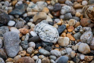 Rocks and pebbles along Marazion Beach in Cornwall, UK.