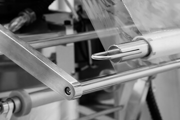 Automatic polyethylene plastic bag production machine. Close-up of roller of plastic bag production...