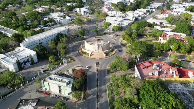 aerial view of monument of la patria on boulevard paseo de montejo in merida yucatan mexico (national heritage monument to the homeland) travel tourism destination with traffic going around a circle