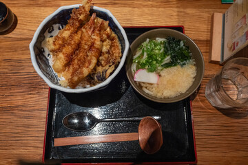 Traditional Japanese tempura rice bowl served with udon soup and soft-boiled egg
