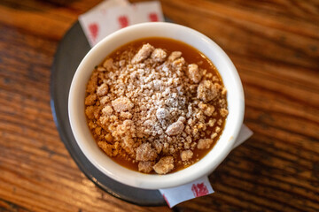 Warm fruit crumble dessert served in a ceramic bowl at a fine dining restaurant