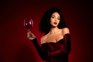 Pretty lady posing looking flirty tempting holding wineglass on red bright color background