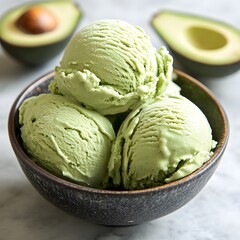 Creamy Avocado Ice Cream: A close-up shot of a bowl filled with scoops of creamy, vibrant green avocado ice cream, alongside fresh avocado halves, inviting a moment of pure indulgence.